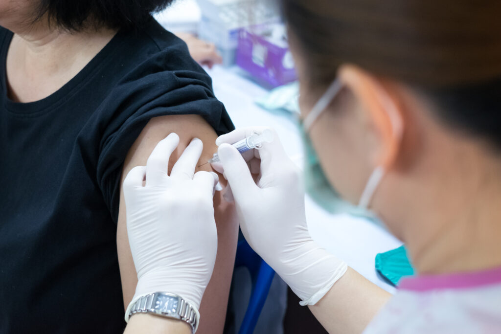 Provider administering vaccine to patient