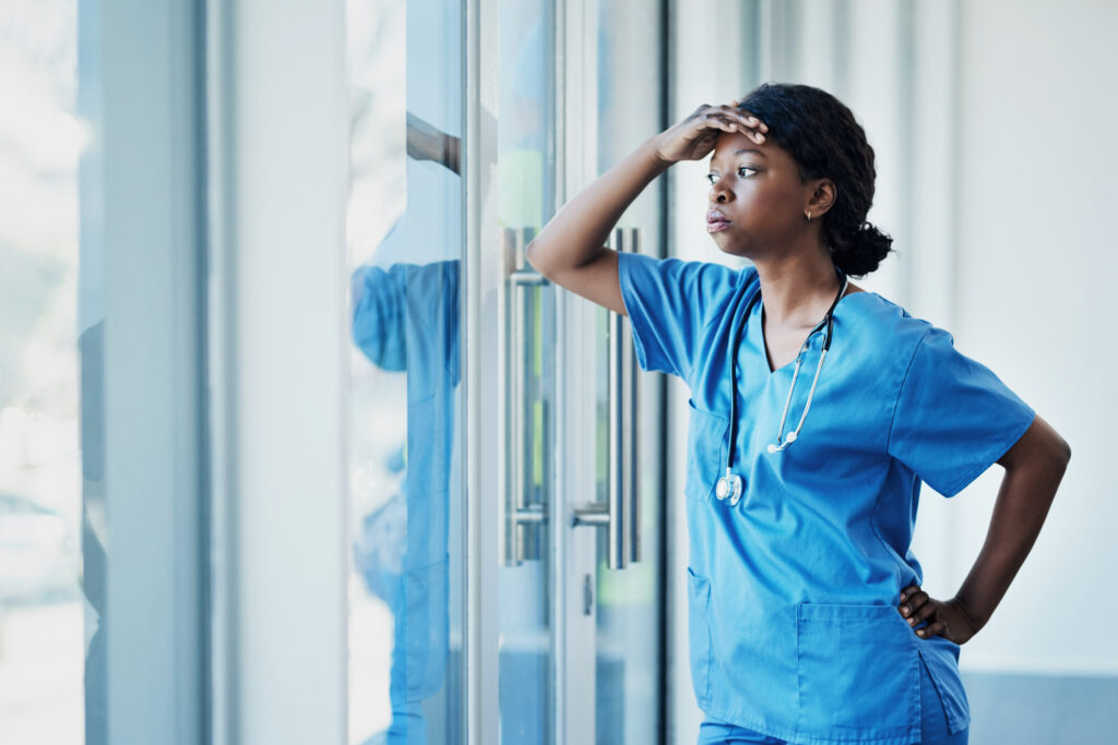 Young female nurse looking stressed out