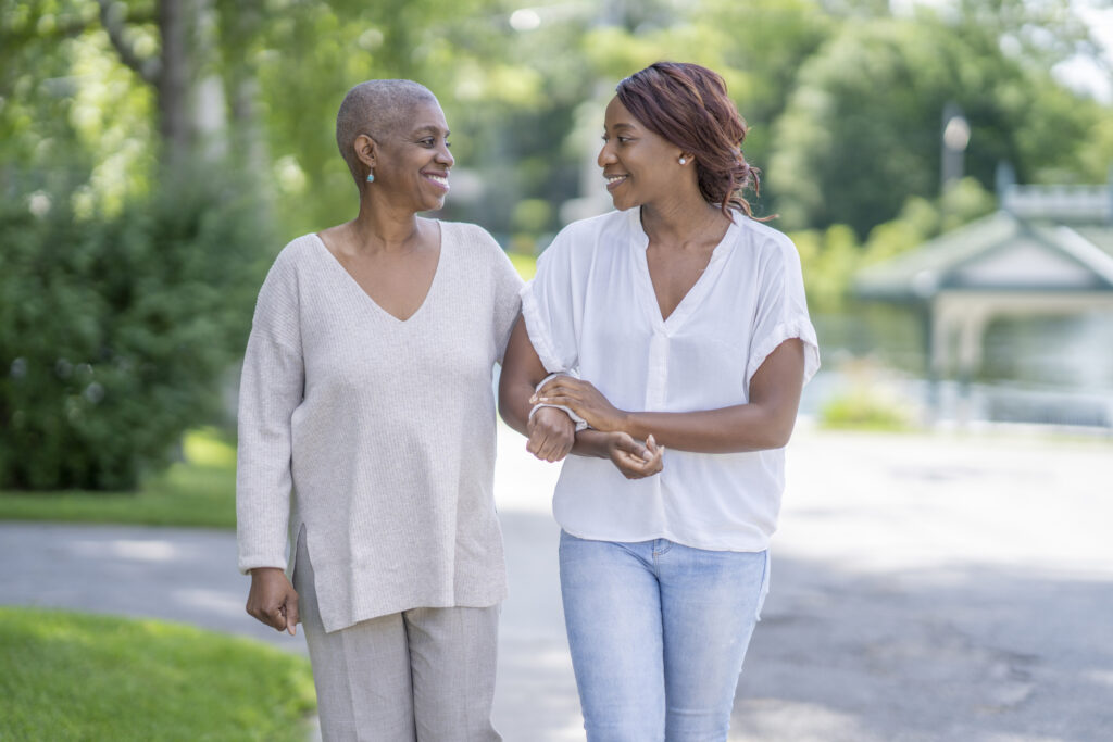 Woman walking with her senior mother