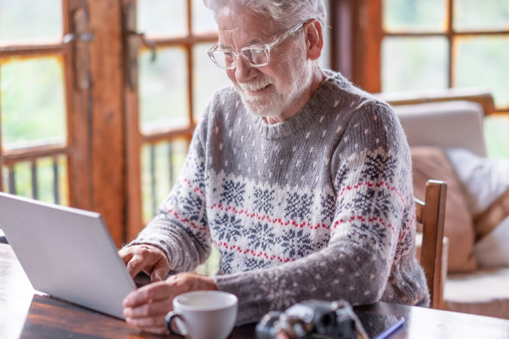 Senior man working on laptop